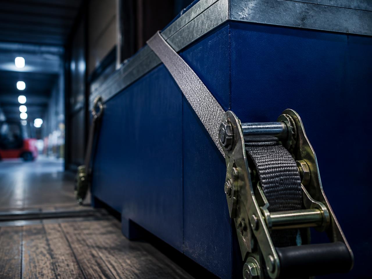 Ratchet strap securing freight inside an AHA Transport trailer